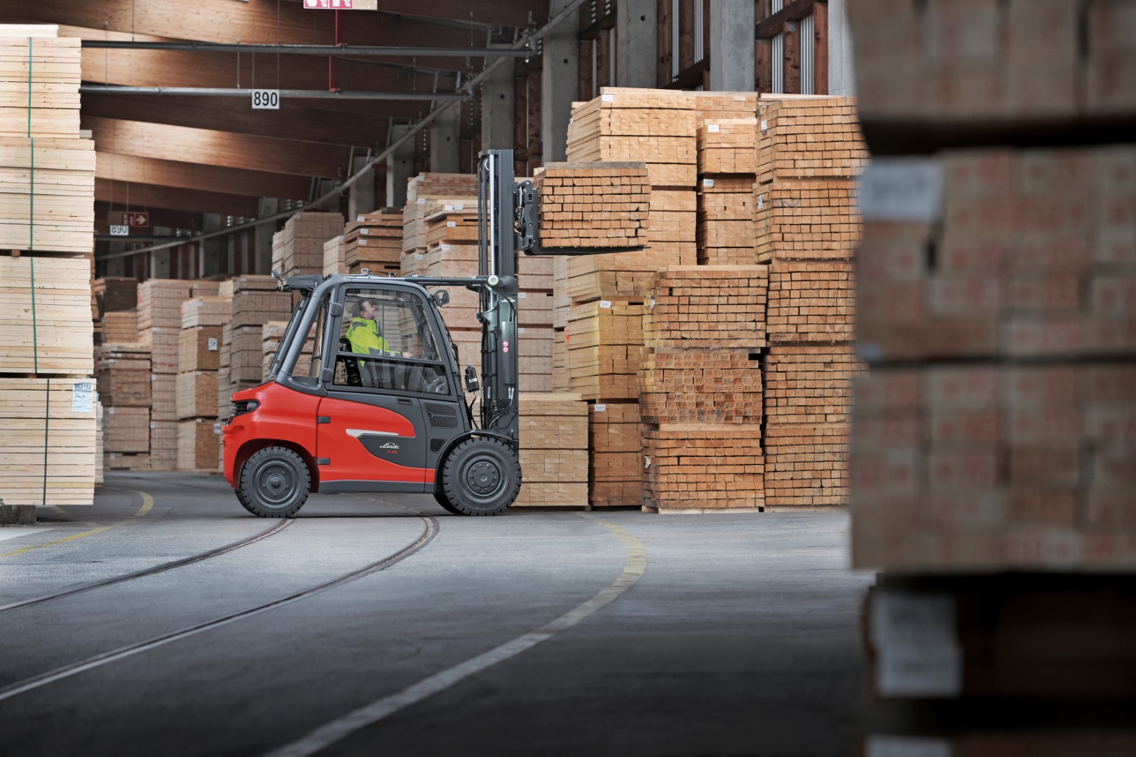 Elektrische Linde heftruck transporteert hout in buitenmagazijn